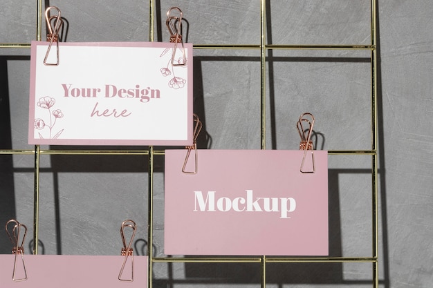 Cards hanging on grid wire board with pink clips