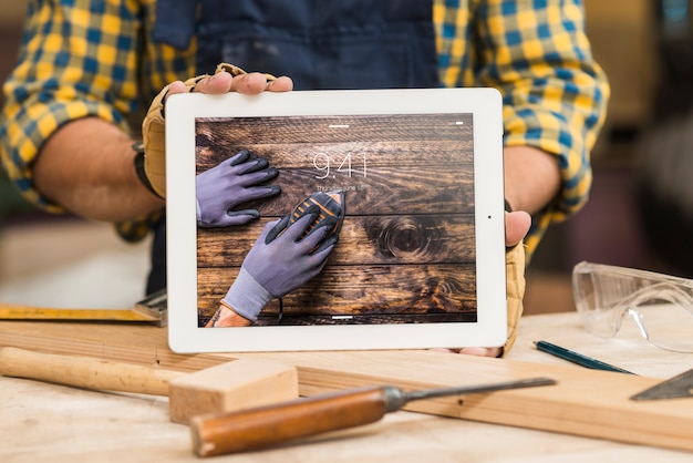 Carpenter holding tablet mockup