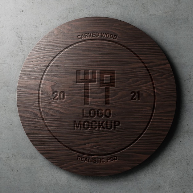 Carved engraved realistic logo mockup on polished circle dark wood on concrete wall