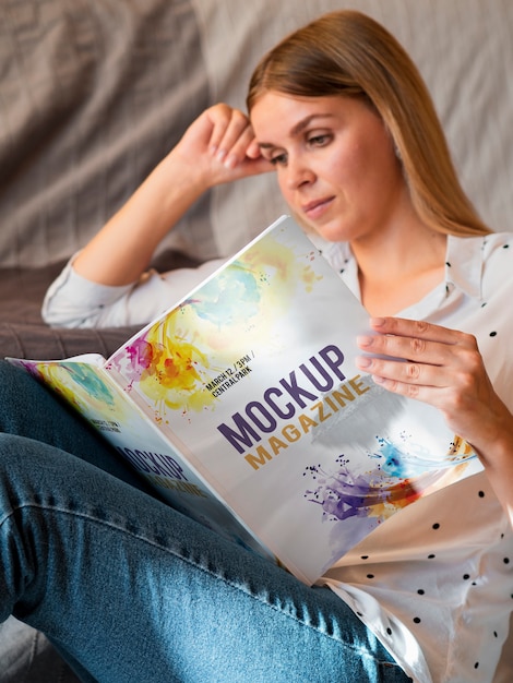 Casual dressed woman reading a mock up magazine