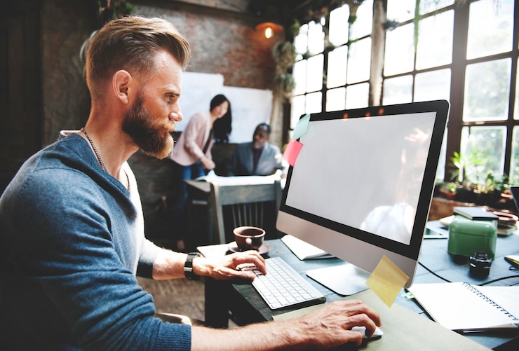 PSD casual man working on a computer in an office