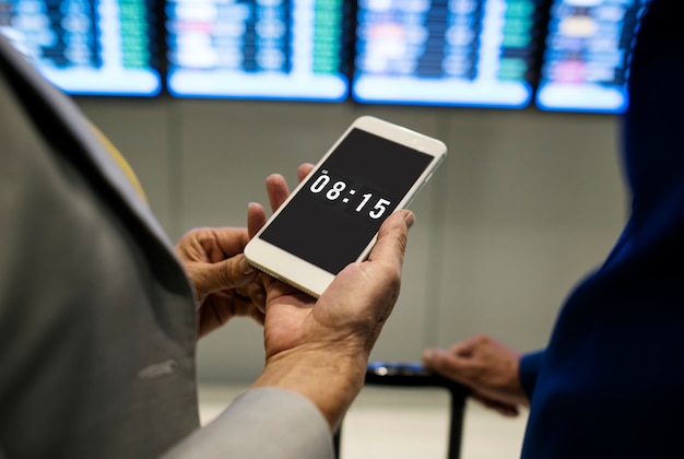 PSD caucasian couple checking flight time schedule