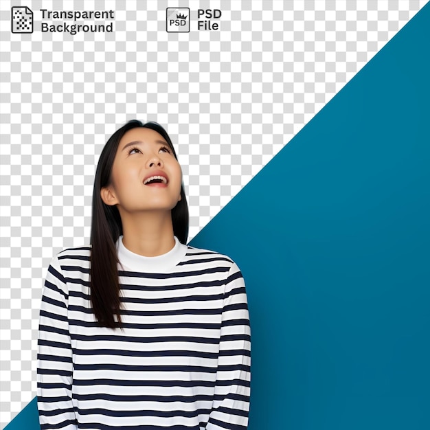 Celebration moment a woman with long black hair and a white and black shirt stands in front of a blue wall her open mouth and brown eye visible her small ear is also visible in the frame