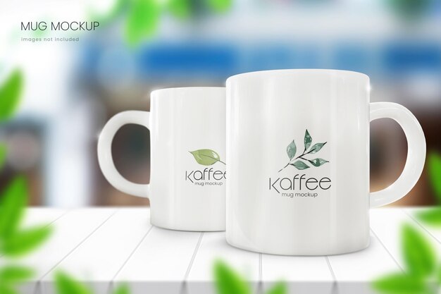 Ceramic coffee mug mockup of two white cup with blurred cafe in background