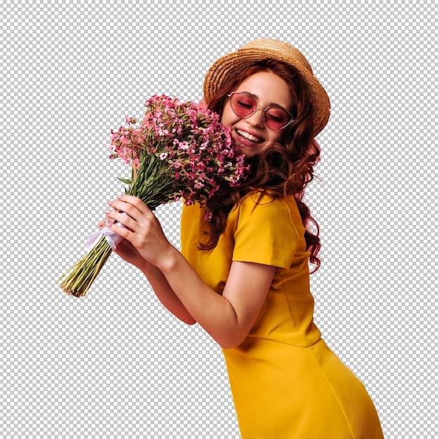 Charming girl in boater and red sunglasses poses with pink flowers