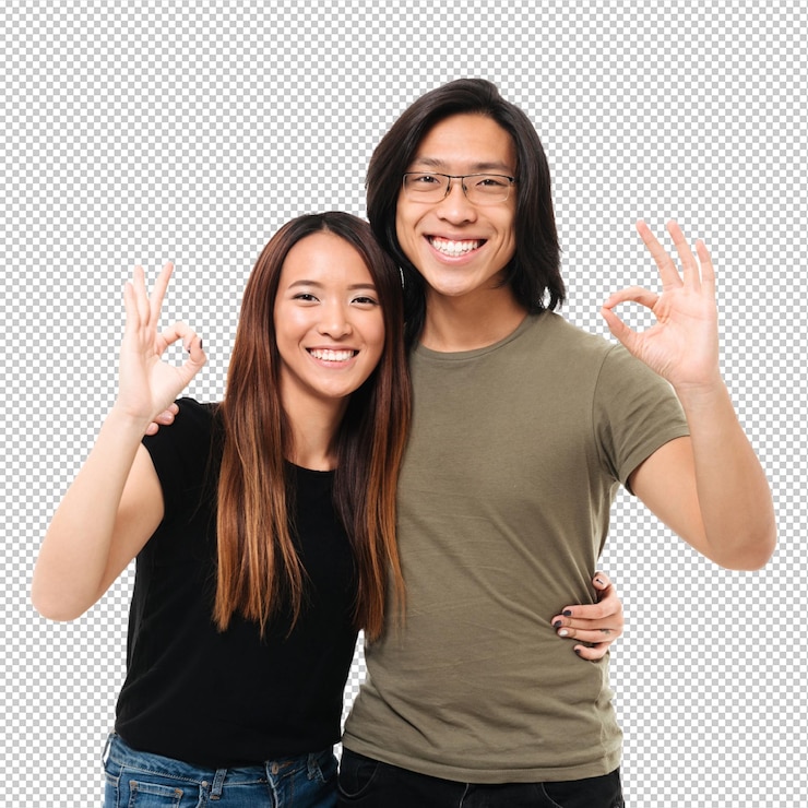 PSD cheerful asian couple showing ok gesture while hugging each other looking at camera