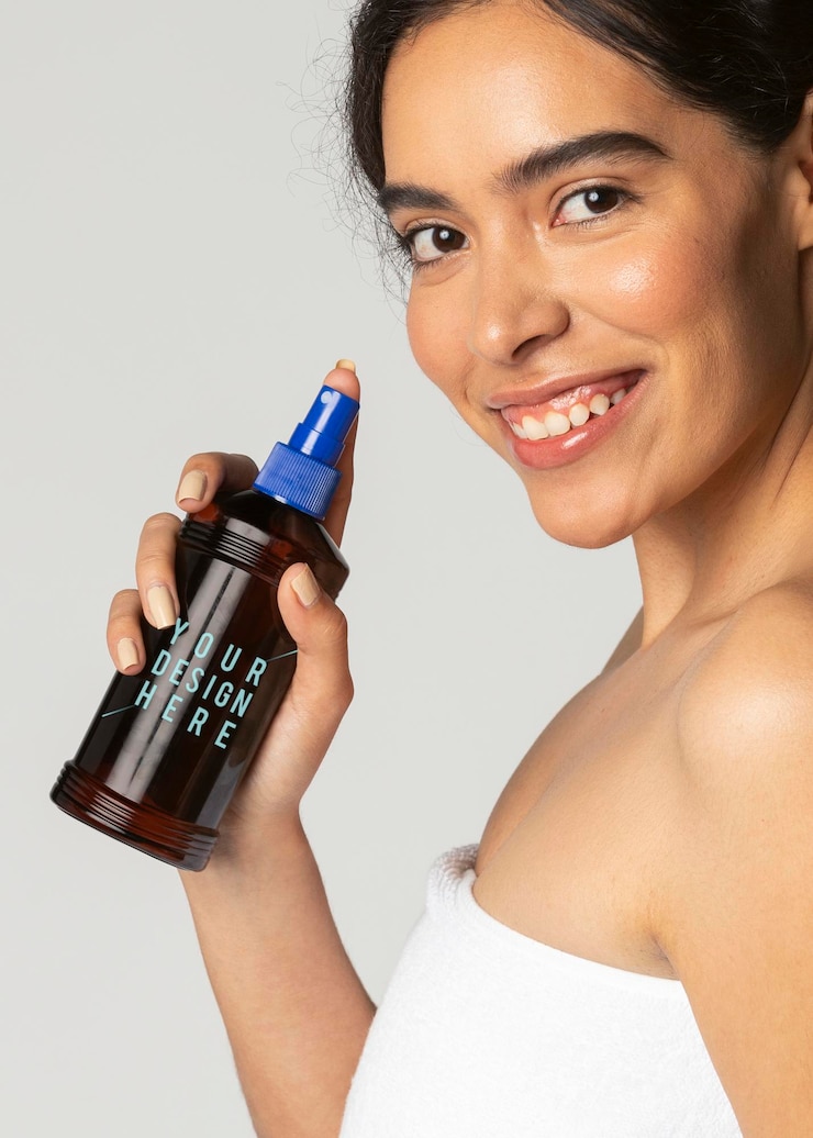 PSD cheerful woman using a sunscreen spray bottle mockup