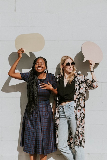 PSD cheerful women showing blank speech bubbles