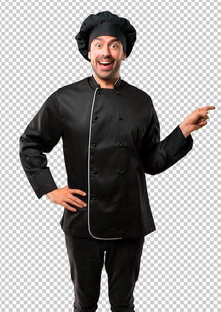 Chef man In black uniform pointing finger to the side and presenting a product