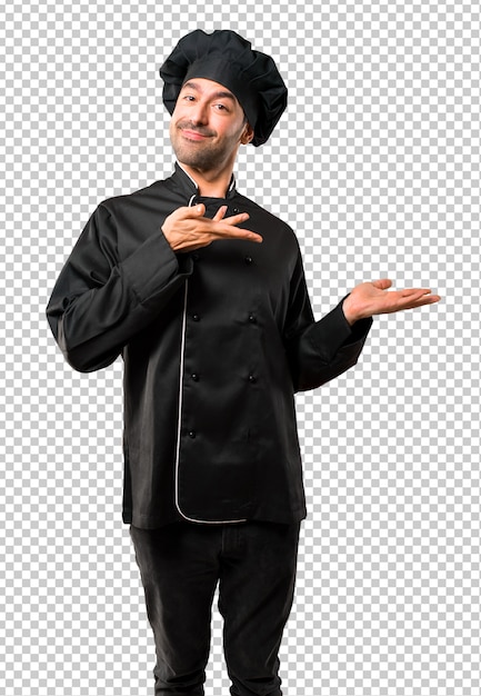 chef man in black uniform extending hands to the side and smiling for presenting 