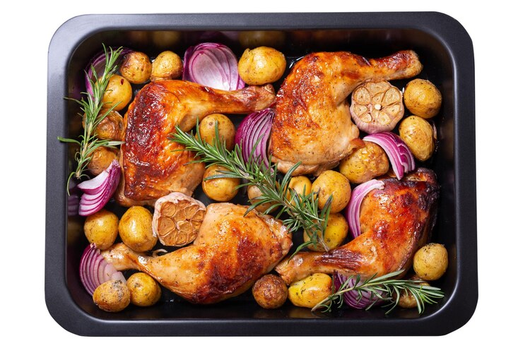 PSD chicken legs with potatoes and rosemary in a baking dish isolated on transparent background top view
