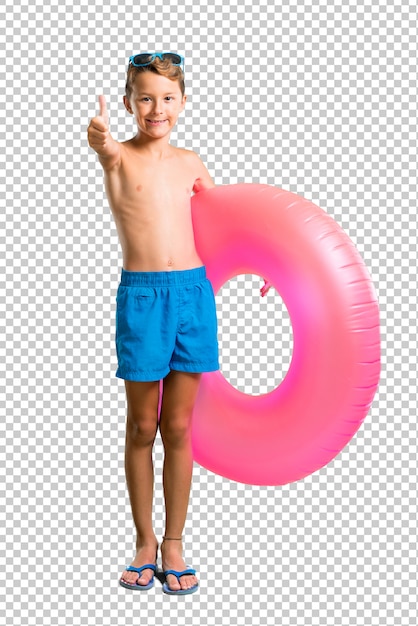 Child on summer vacation giving a thumbs up gesture and smiling
