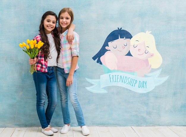 Children holding each other with wall mock-up