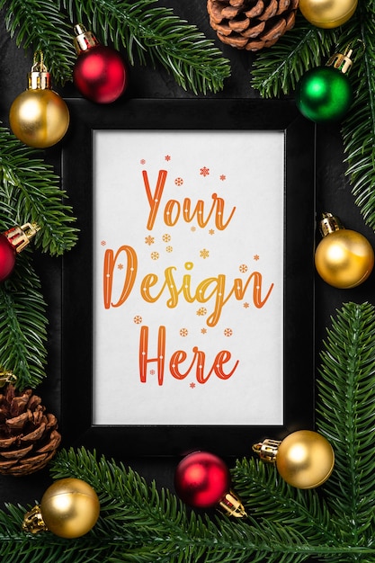 PSD christmas composition with empty picture frame. colorful ornament, pine cones and fir needles decorations. mock up greetings card template