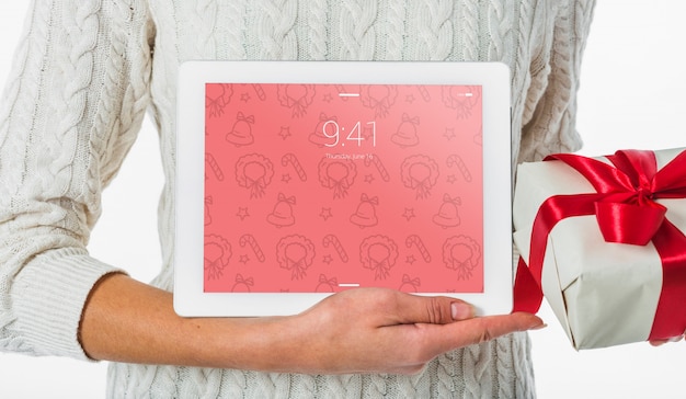 Christmas concept with woman holding tablet mockup