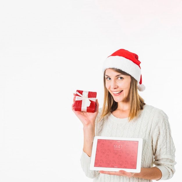 Christmas concept with woman holding tablet mockup