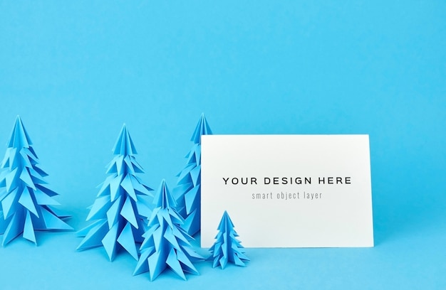 PSD christmas greeting card mockup with blue paper fir trees