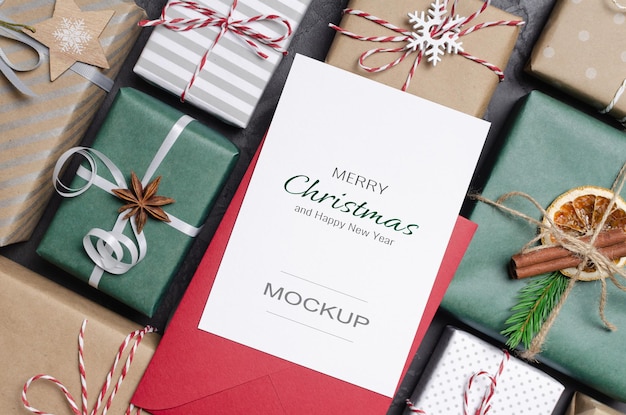 Christmas greeting card mockup with envelope and festive decorated gifts