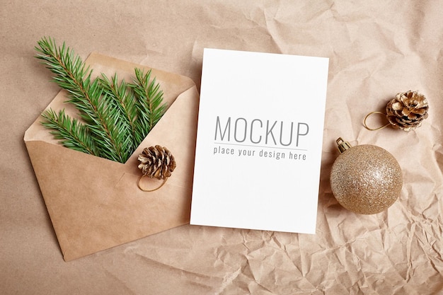 Christmas greeting card mockup with festive decorations and envelope with green fir tree branch