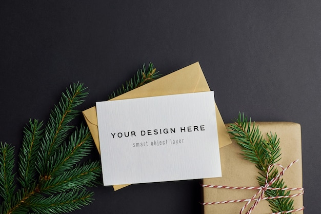 christmas greeting card mockup with gift box and fir tree branches on black