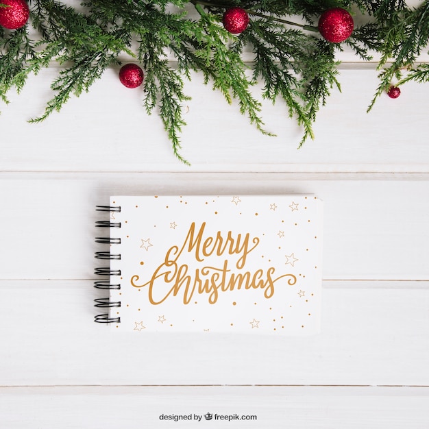 PSD christmas mockup with notepad below mistletoe