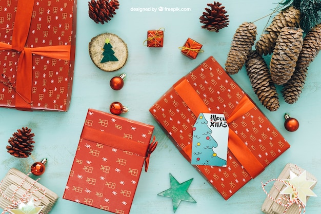 PSD christmas mockup with present boxes and pine cones