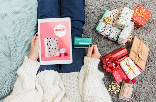 Christmas sale mockup with woman using tablet