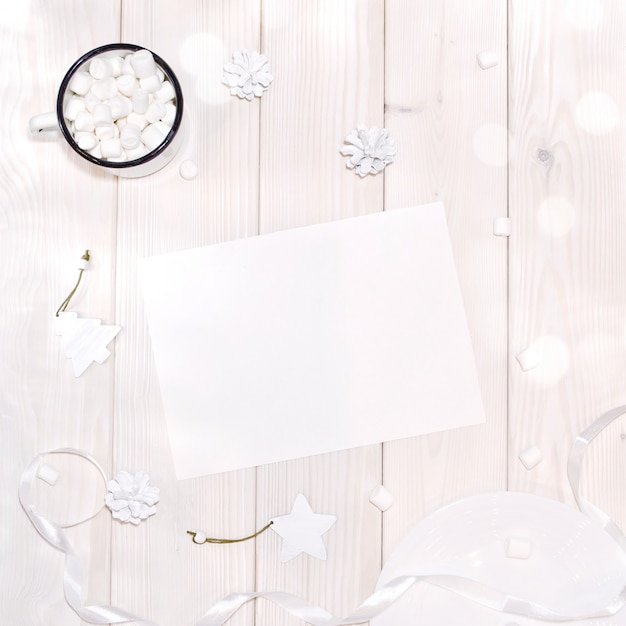 PSD christmas with card mockup and white decorations on  wood table