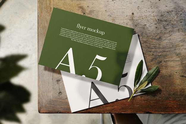 PSD clean minimal a5 flyer mockup on top table with plant background psd file