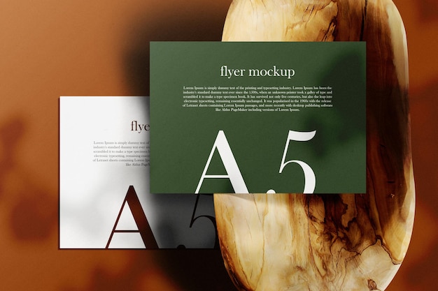 Clean minimal a5 flyer mockup on wooden plate with light and shadow