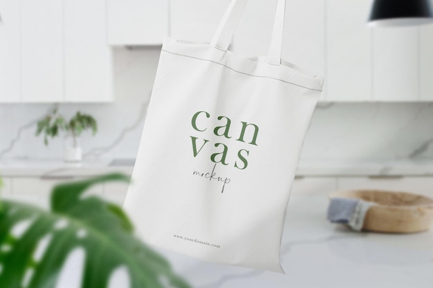 Clean minimal bag canvas mockup floating on top table with leaves