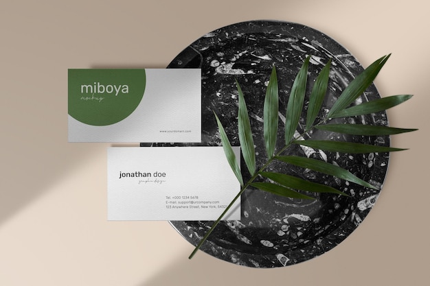 Clean minimal business card mockup on black marble plate