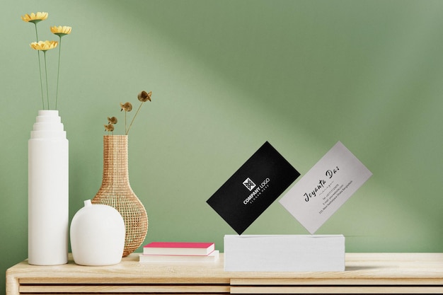 PSD clean minimal business card mockup floating on table with leaves and vase