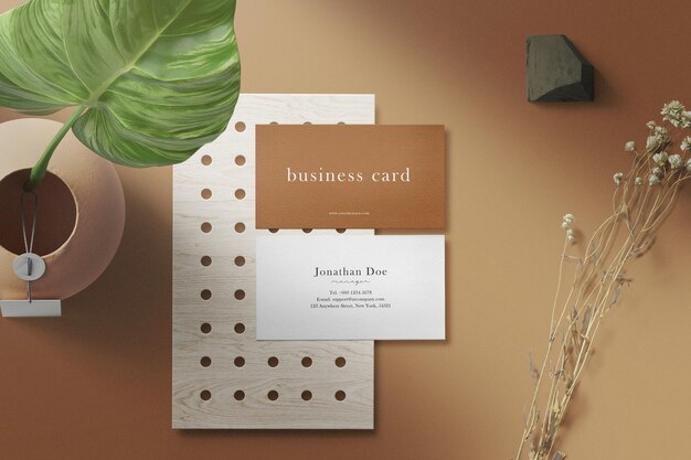 Clean minimal business card mockup on plate with vase flower and dry plant