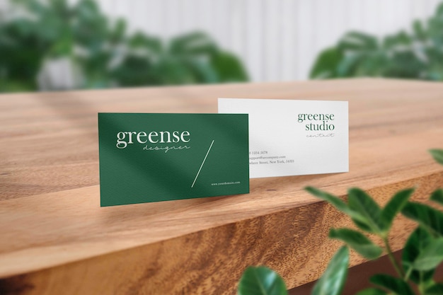 Clean minimal business card mockup on wood brown table and light shadow