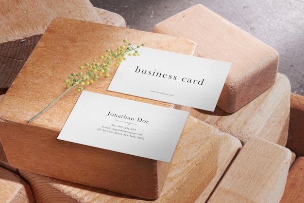 Clean minimal business card mockup on wooden blocks with plant