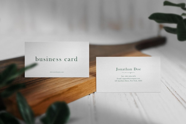 Clean minimal business card mockup on wooden plate