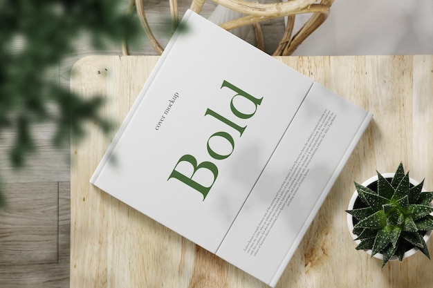 Clean minimal cover square book mockup on top wooden with plants