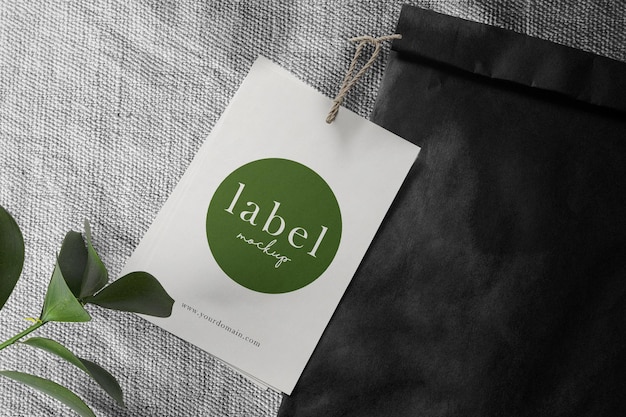 Clean minimal label mockup on close up cotton background with bag and branch