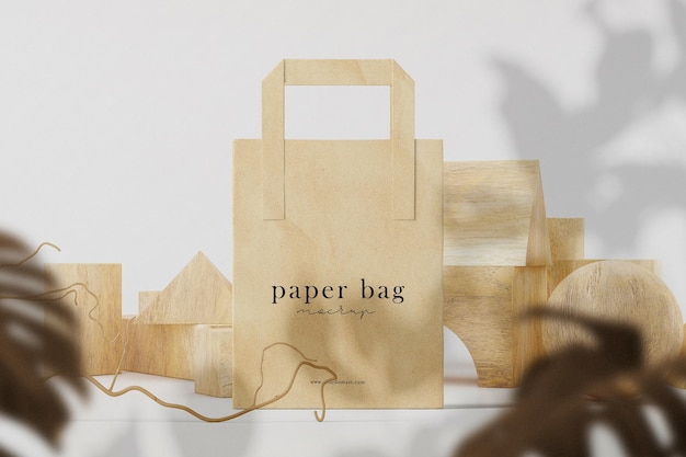 Clean minimal paper bag mockup on front wooden block and leaves background. psd file.