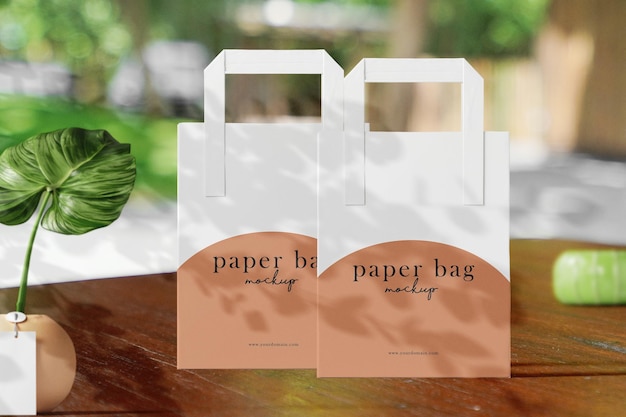 Mockup di sacchetto di carta minimo pulito sullo sfondo del giardino con pianta e vaso