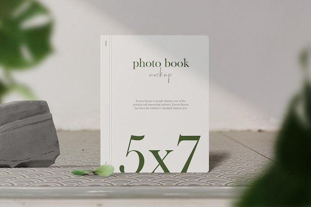 PSD clean minimal photo book 5x7 mockup standing on bench with block and pencil