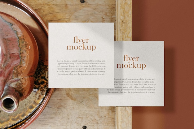 Clean minimal square flyer mockup floating on top wooden with tea set