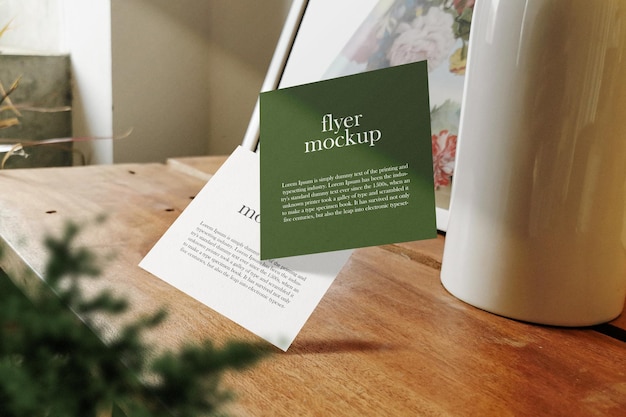 PSD clean minimal square flyer mockup floating on wooden top with vase psd file