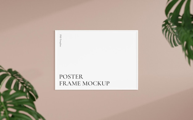 Mockup di cornice per poster o foto in bianco orizzontale con vista frontale pulita e minimalista appeso al muro con rendering 3d di piante sfocate