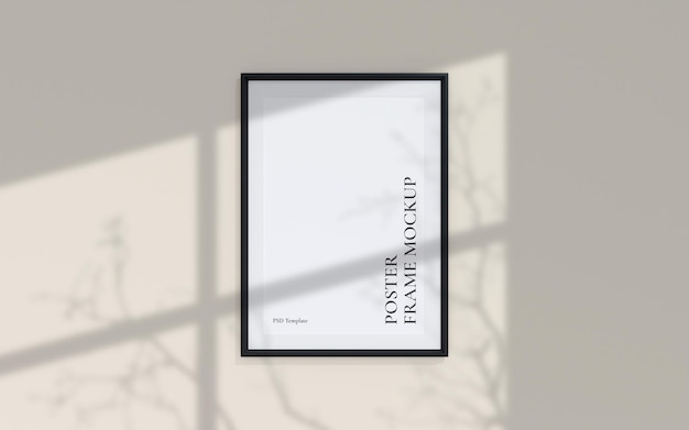 Clean and minimalist front view portrait black photo or poster frame mockup hanging on the wall with shadow overlay 3d rendering