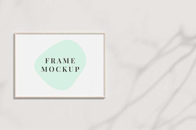 Clean and minimalist front view vertical white photo or poster frame mockup hanging on the wall with copy space