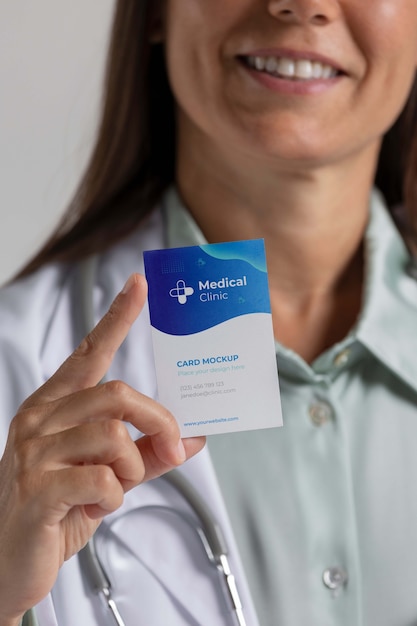 Clinic doctor holding business card mockup