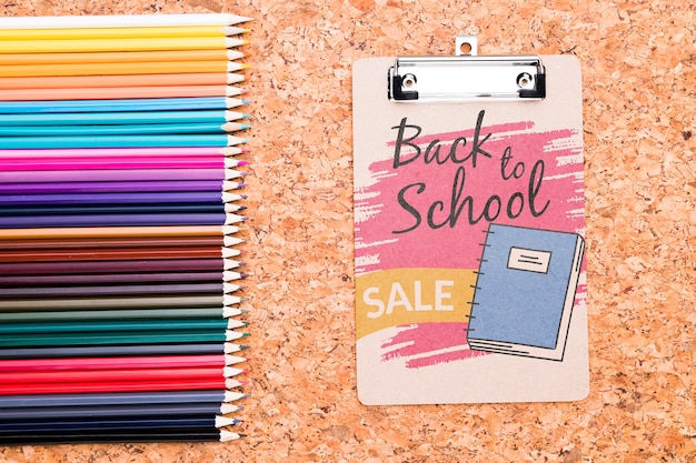 Clipboard next to colorful pencils mock-up