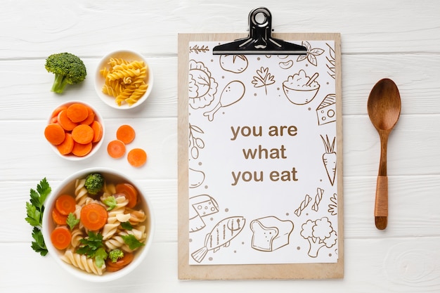 Clipboard with organic vegetables beside